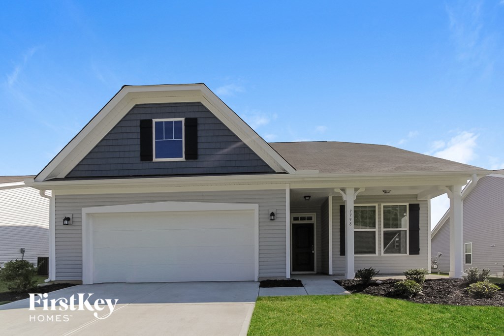 a white house with a white garage door