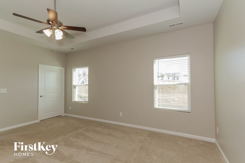 a living room with a ceiling fan and a window