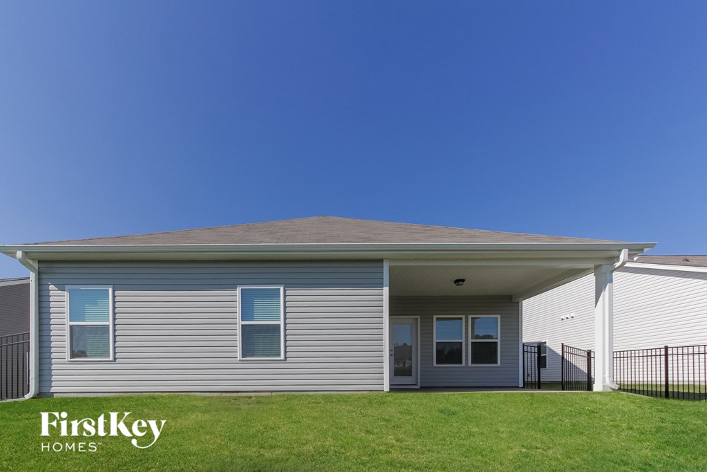 a white house with a yard and a blue sky
