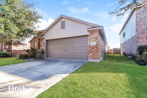 a garage door in front of a brick house