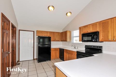 a kitchen with black appliances and white counter tops