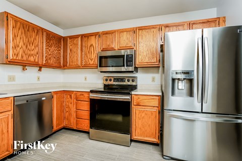 a kitchen with stainless steel appliances and wooden cabinets