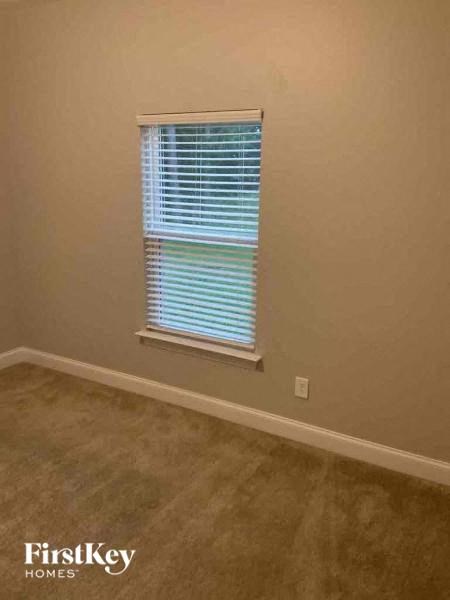 A room with a window covered in blinds.