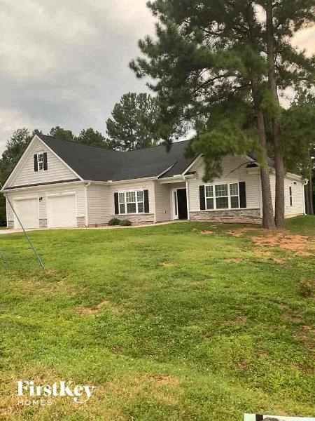 A house with a lawn in front of it.