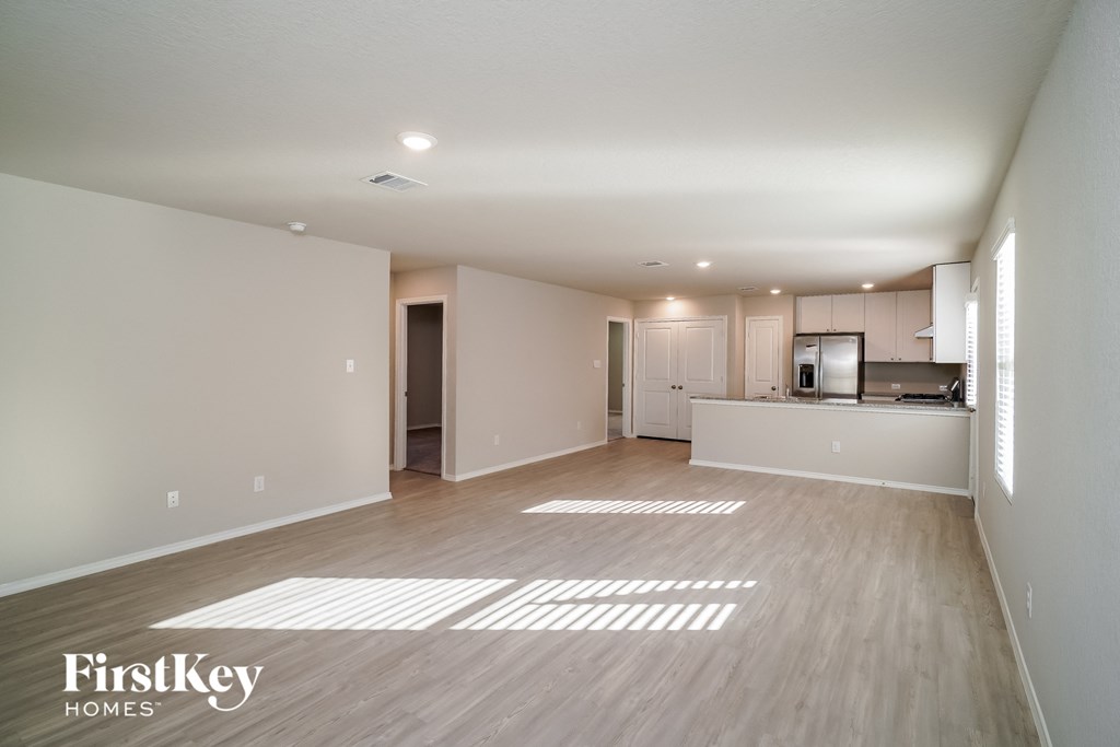 an empty living room and kitchen in a house