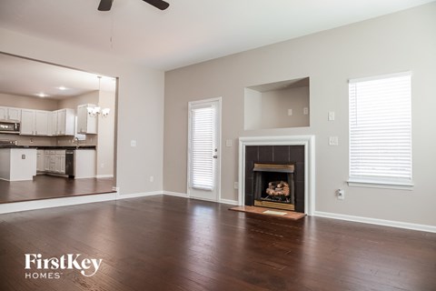 a living room with wood floors and a fireplace