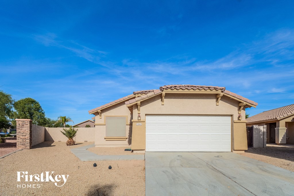 A house with a garage door is for sale by FirstKey Homes.