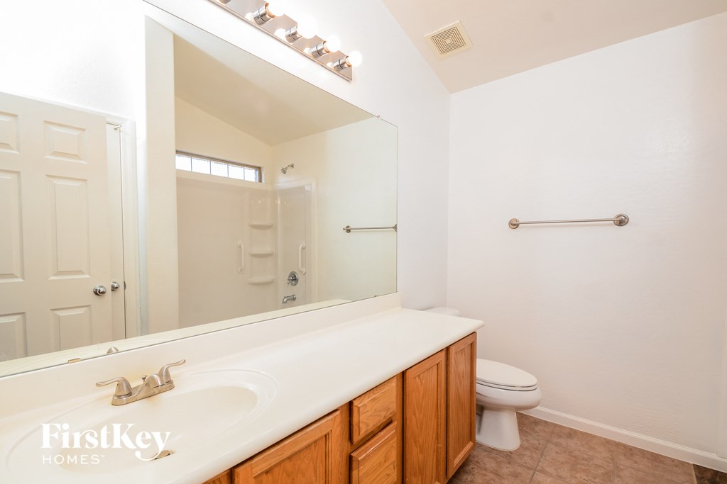 A bathroom with a white sink and a mirror.