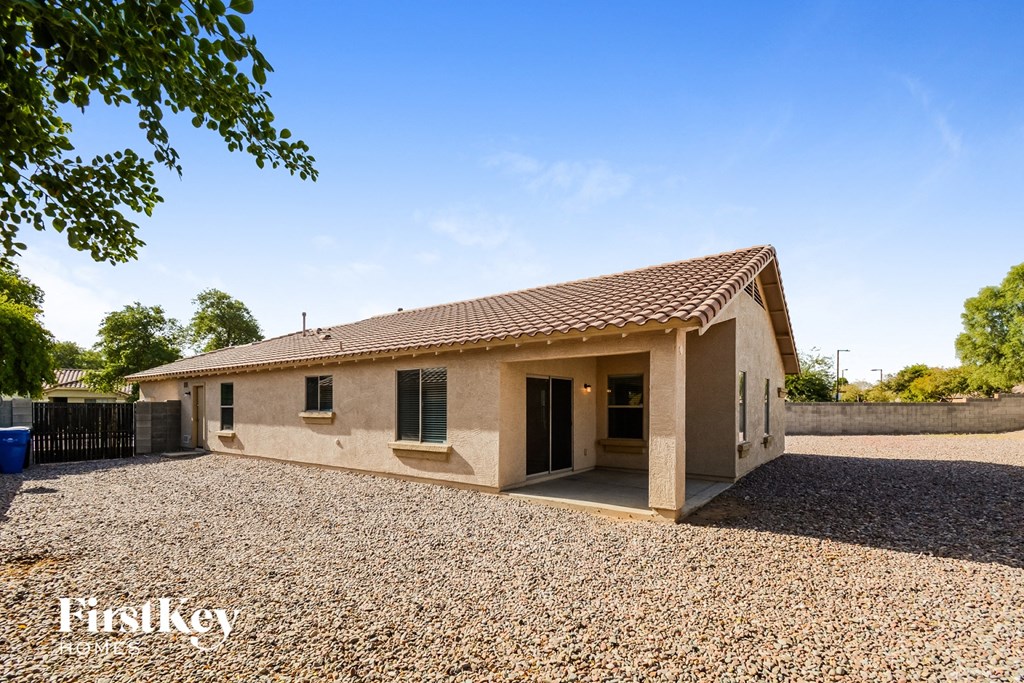 A house with a gravel driveway in front of it.