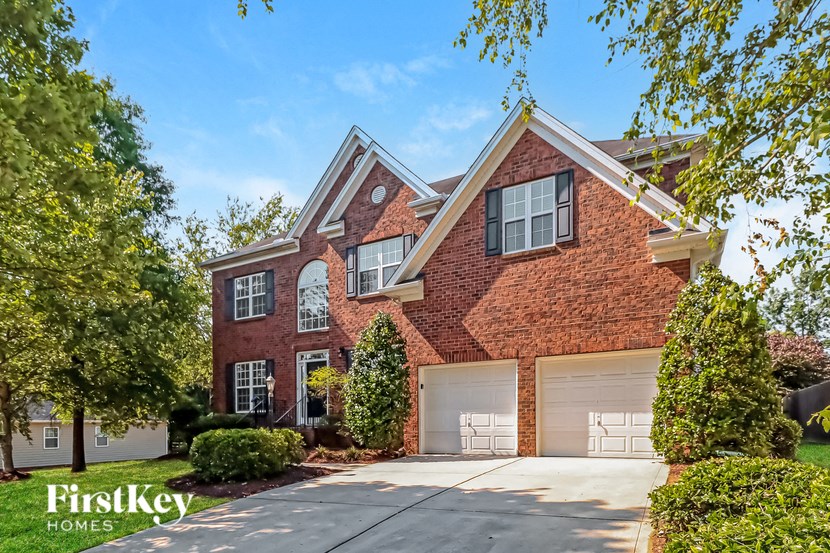 a red brick house with a white garage door