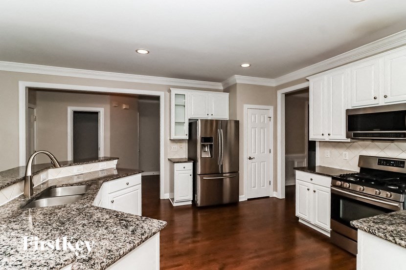 a kitchen with granite counter tops and stainless steel appliances