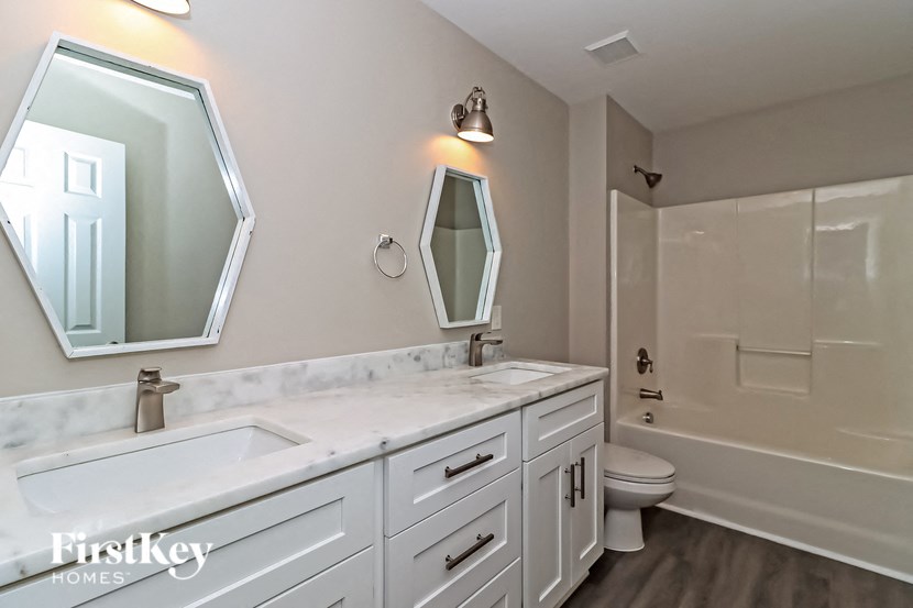 a bathroom with a sink and a toilet and a shower