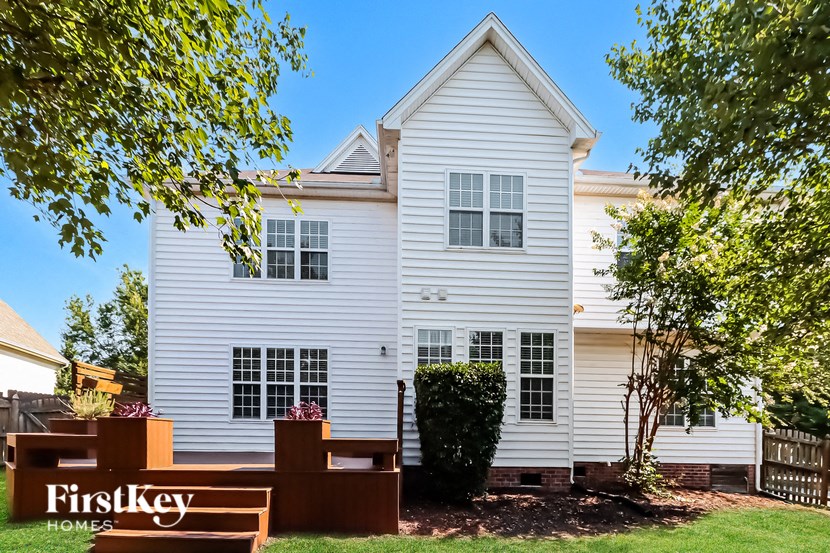 a white house with a yard in front of it