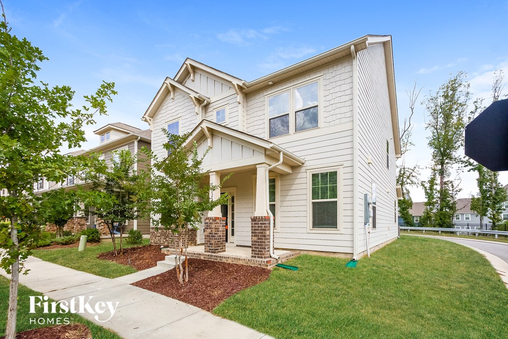 a white house with a sidewalk in front of it