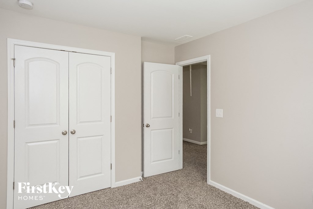 a bedroom with two closets and a door to a closet