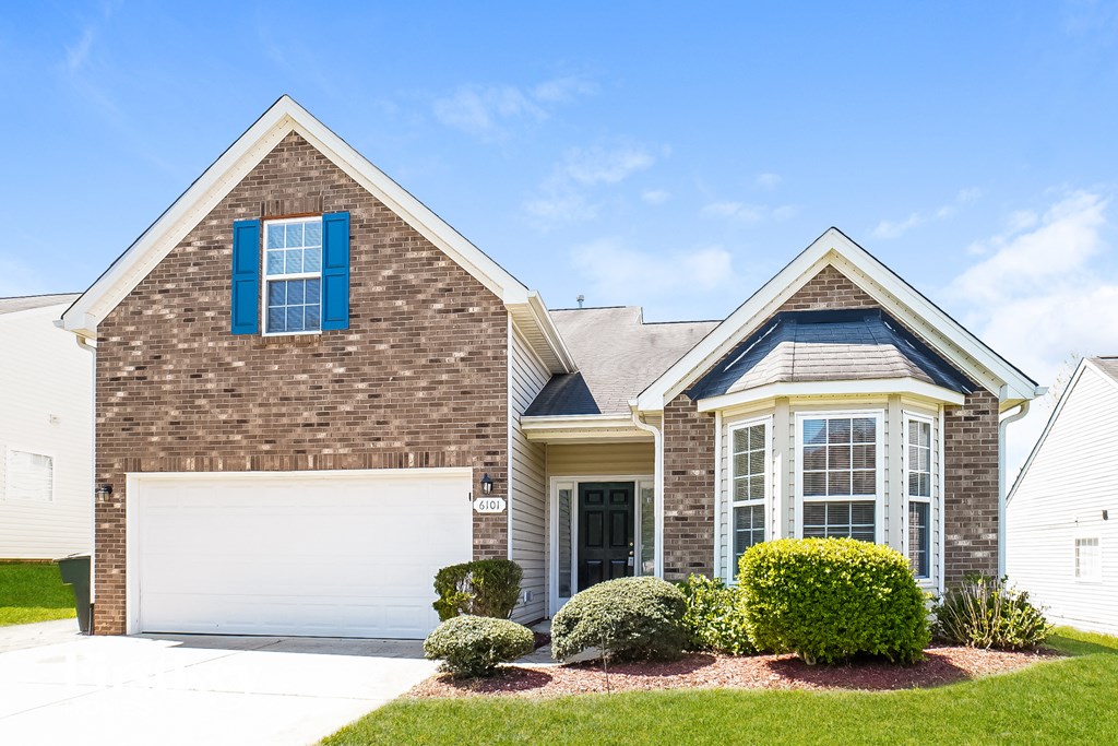 a house with a garage door in front of it