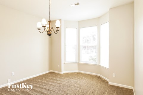 a living room with a carpet and a chandelier
