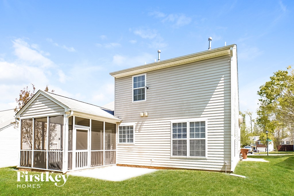 a small white house with a porch and a screened in porch