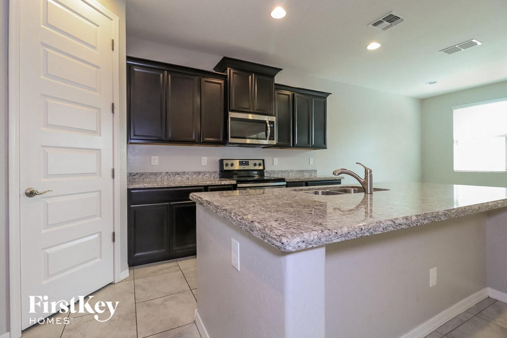 A kitchen with a granite countertop and a sink.