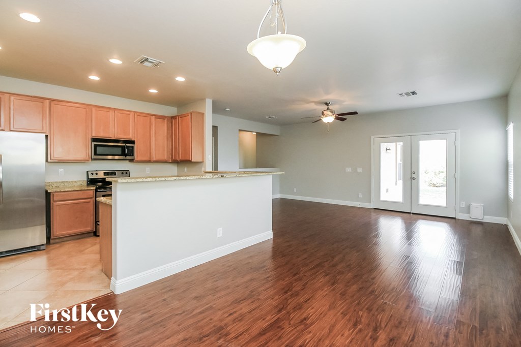 A kitchen with wooden floors and a white counter.