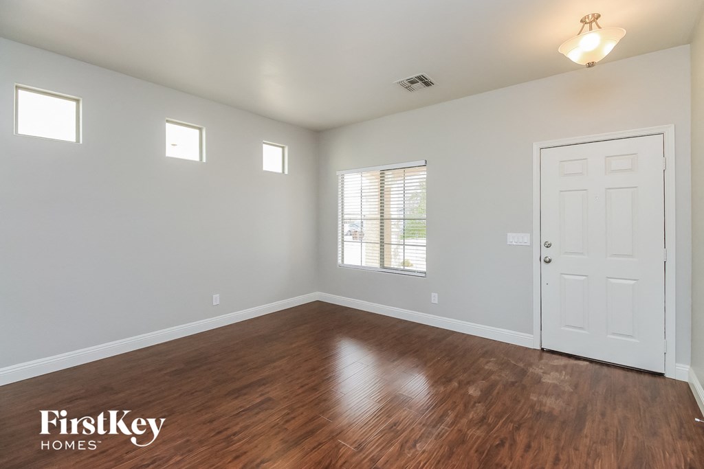 A room with wooden floors and a white door.