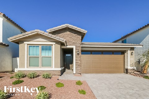 A modern house with a brown garage door and a clear blue sky.