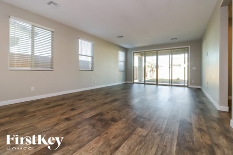 A room with wooden floors and a sliding glass door.