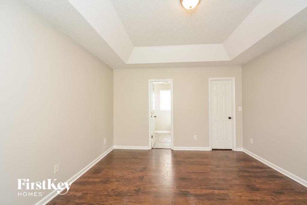 A room with wooden floors and white walls.