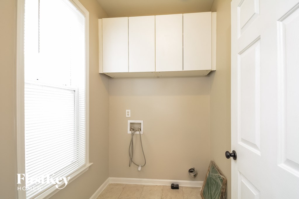 A bathroom with a shower head and a window.