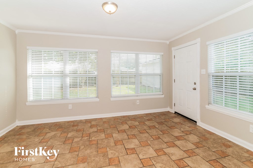 the dining room is spacious and has a door to the kitchen