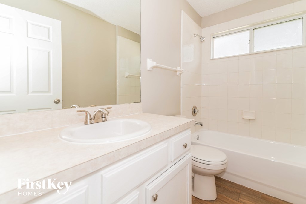 a bathroom with a sink and a toilet and a tub