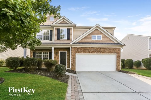 a home with a white garage door in front of it