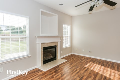 a living room with a fireplace and a wooden floor