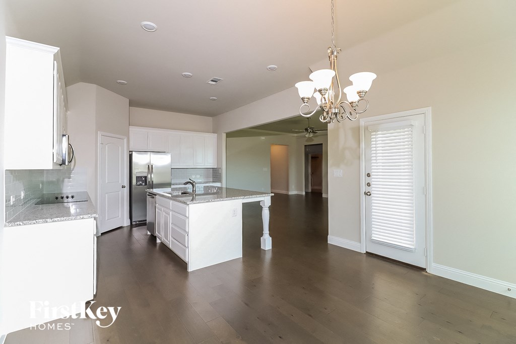a large kitchen with white cabinets and a white counter top