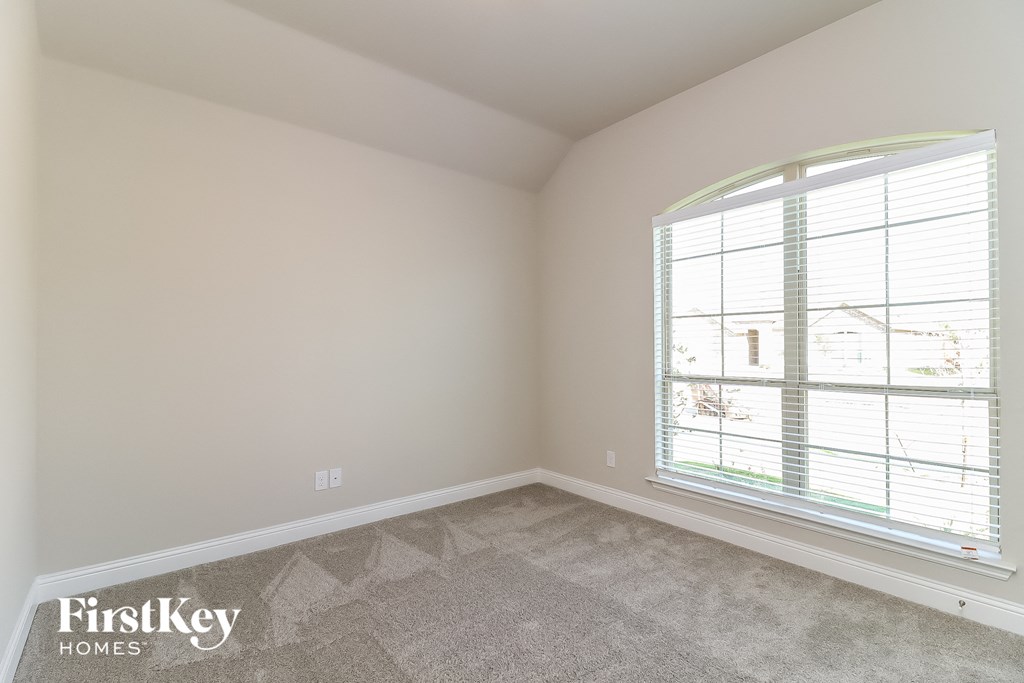 the living room of a home with a large window