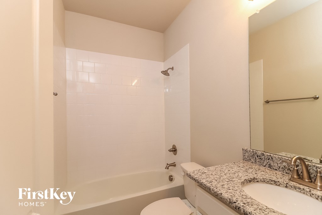 a bathroom with a tub and a sink and a toilet