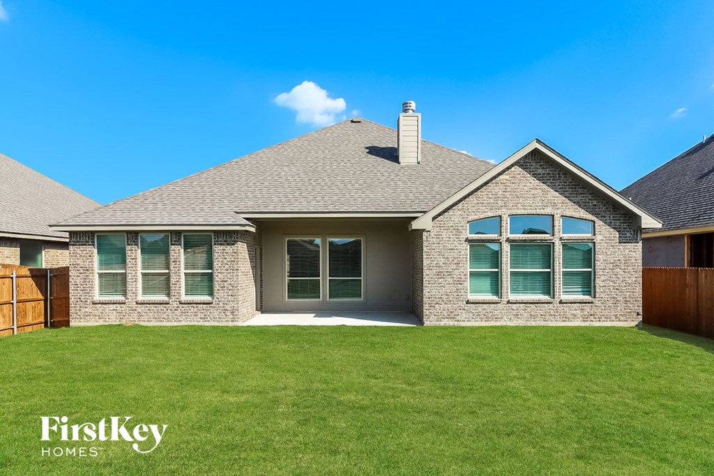 front view of a home with green grass and a blue sky