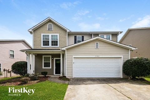 a tan house with a white garage door