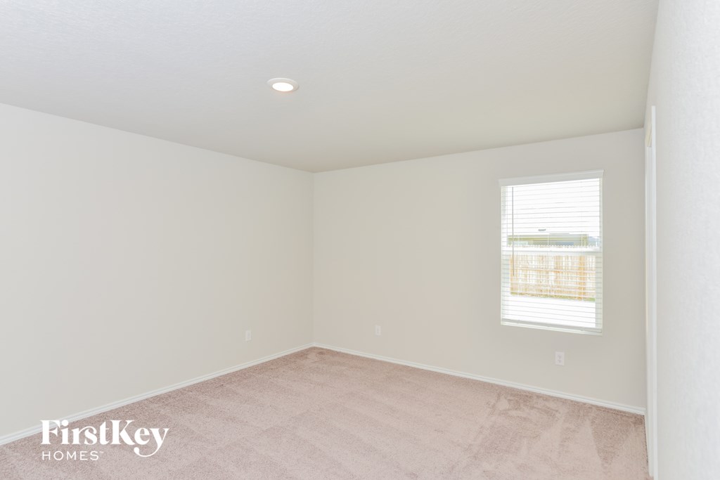 an empty room with white walls and a window