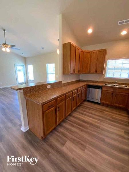 A kitchen with wooden cabinets and a countertop.