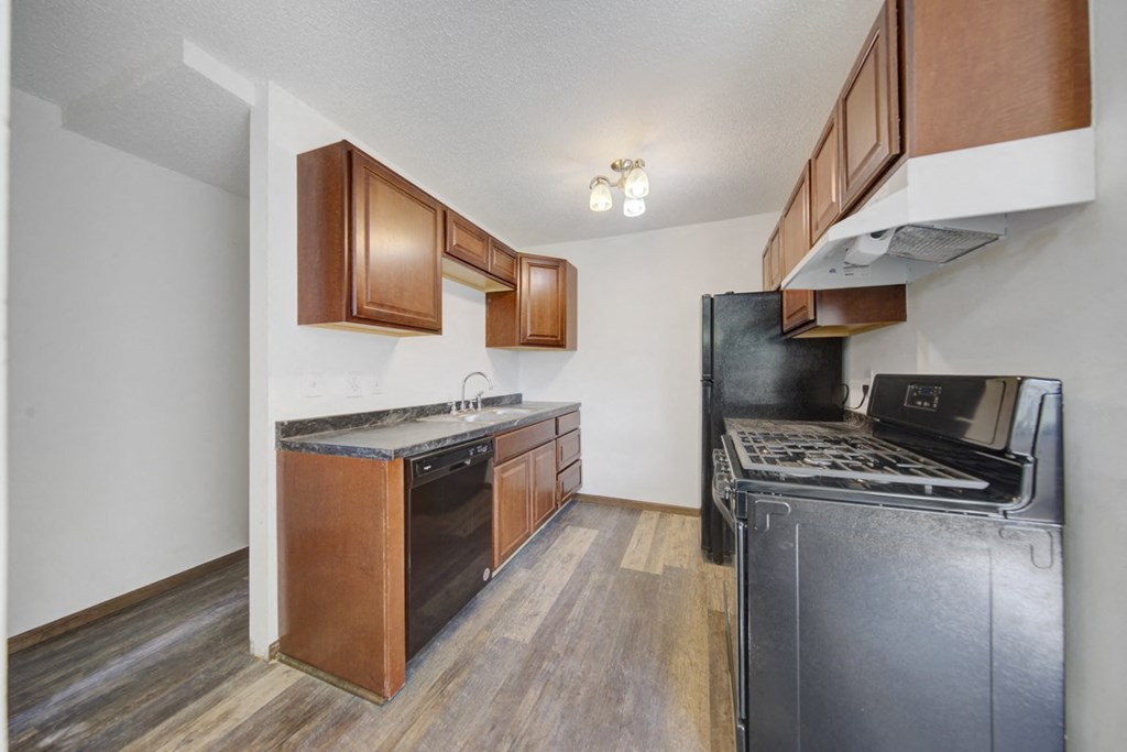 a kitchen with stainless steel appliances and wooden cabinets