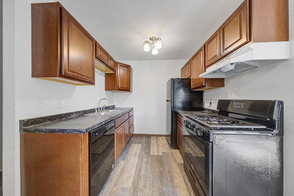 a kitchen with stainless steel appliances and wooden cabinets