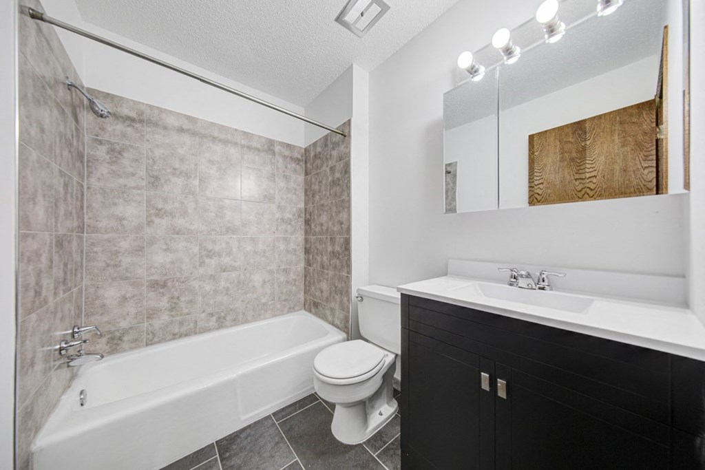 a bathroom with a sink toilet and a bath tub