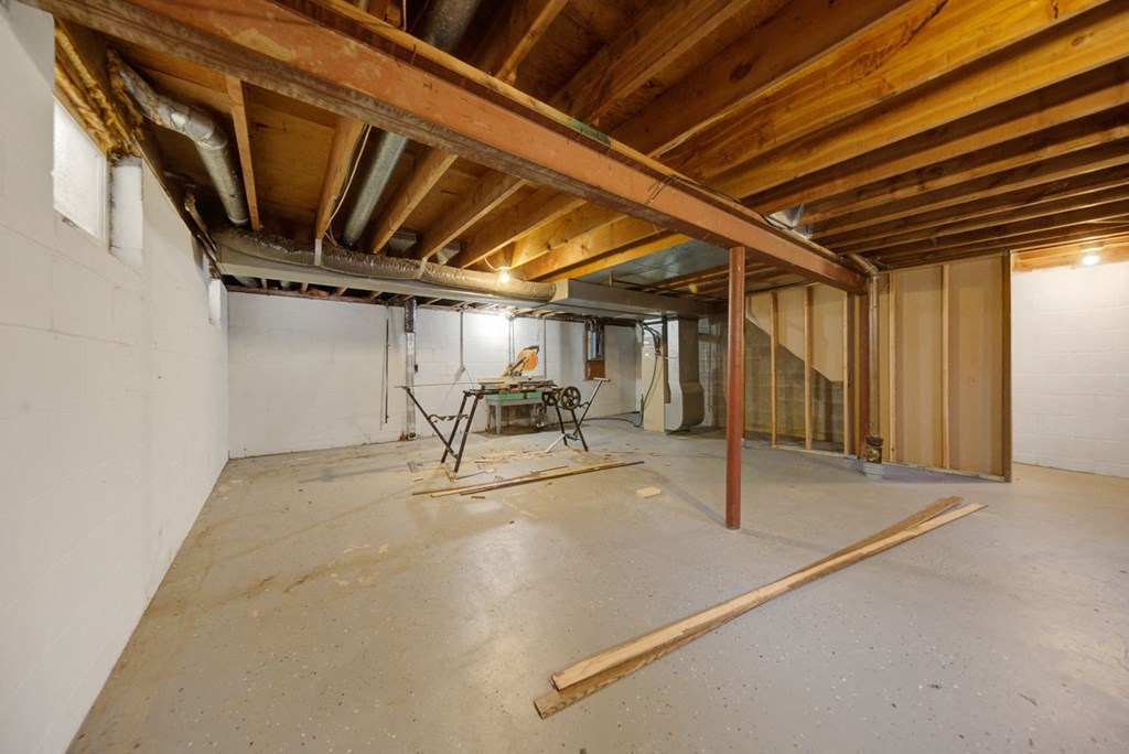 a large unfinished basement with a table in it
