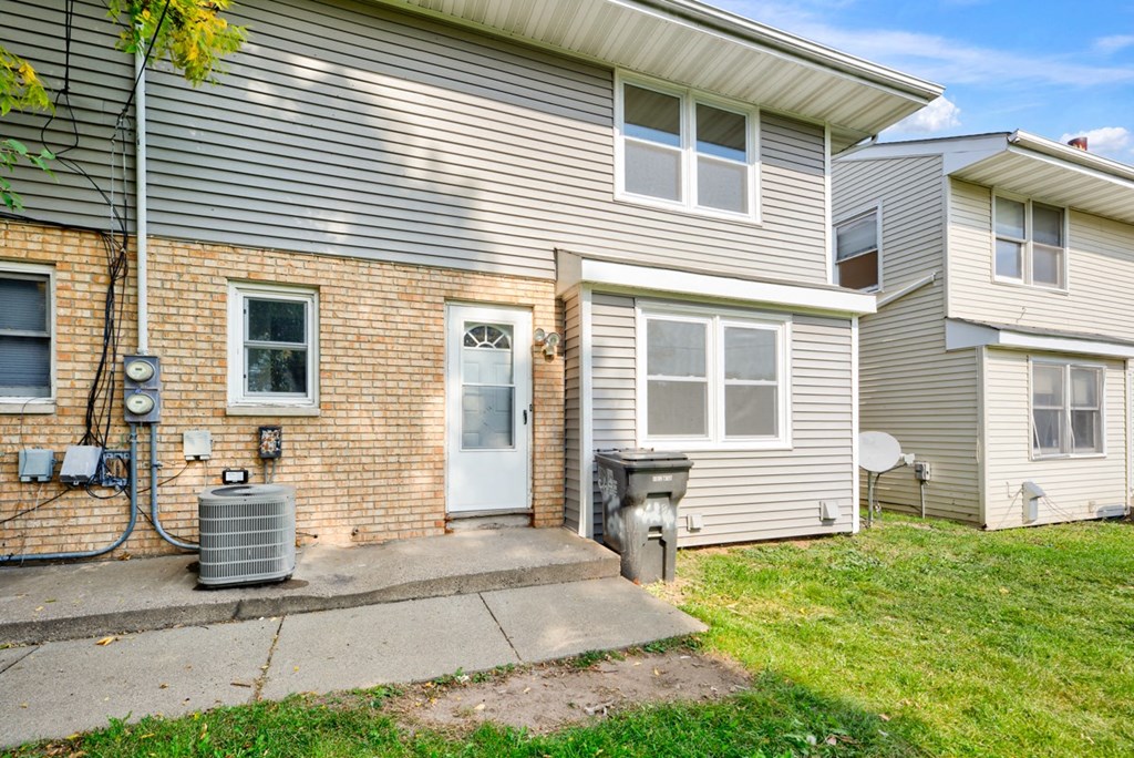 the front of a house with a backdoor and a sidewalk