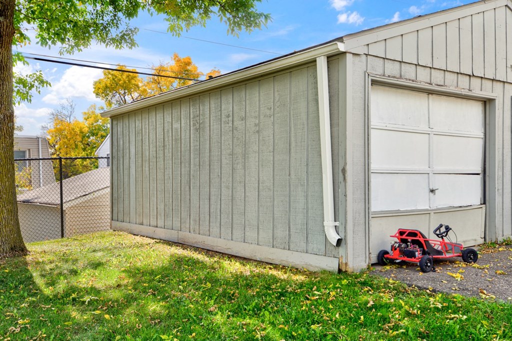 the side of a garage with a toy car outside of it
