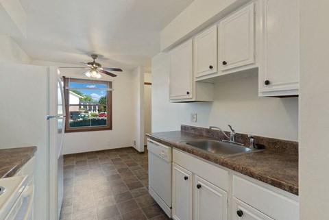 a kitchen with a sink and a refrigerator