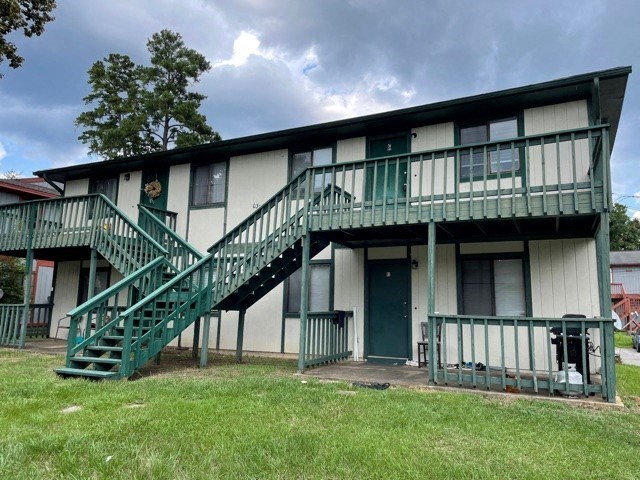 a building with two sets of green stairs