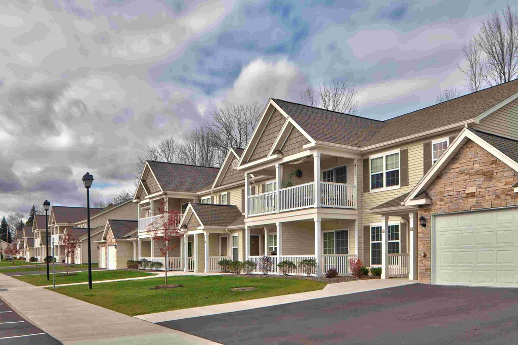 a row of houses on a street with a street light
