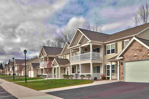 a row of houses on a street with a street light
